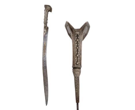 Ca. 19th century AD An Islamic-Turkish sword with a characteristic doubled-eared silver hilt decorated with repoussé and engr