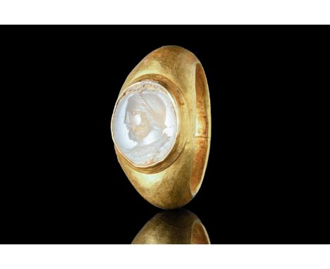 Ca. AD 100 - 300 A D-shaped gold ring composed of a slender hoop with large shoulders and a bezel with an intaglio. This beze
