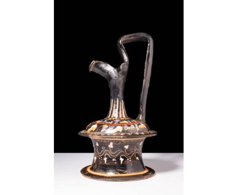 Ca. 350 - 300 BC A Gnathian black-glazed pottery pouring vessel, or epichysis. Characterized by its distinct spool-shaped bas