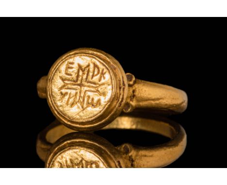 Ca. AD 500 - 800 A Byzantine solid gold ring featuring a banded oval hoop, ending in shoulders adorned with geometric motifs 