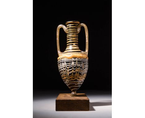 Ca. 200 BC - AD 100 A superb Eastern Mediterranean core-formed glass amphoriskos once used to hold perfumed oil. This vase ha