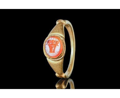 Ca. AD 100 - 300 An elegant Roman gold finger ring with a stepped round hoop, connected to enlarged shoulders. These shoulder