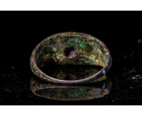 Ca. AD 100 - 300 A Roman bronze ring with a red jasper portrait intaglio of Jupiter. The ring is a round hoop with D-section 