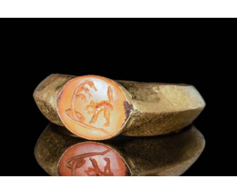 Ca. AD 200 - 300 A Roman gold ring, formed from a round hoop with a triangular cross-section and a bezel that secures a carne