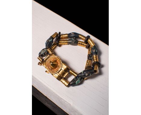 Late Period, Ca. 664 - 332 BC A Late Period Egyptian gold medallion with concentric circles set in a square bezel. This is co