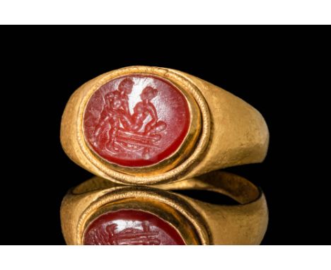 Ca. AD 200 - 300 A Roman gold ring with a carnelian intaglio depicting an erotic scene. The hoop has a D-section. For similar