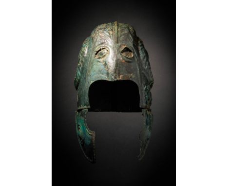 Ca. 500 - 400 BC A rare Chalcidian bronze helmet with angular ribs hammered outwards on each side. The helmet is decorated wi