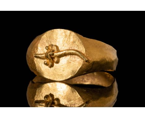 Ca. 305 - 30 BC A Ptolemaic gold ring with a broad, a D-section hoop expanding to form a round flat bezel adorned with a moul