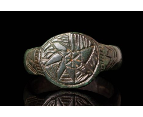 Ca. AD 900 - 1300 A Medieval bronze ring featuring a round hoop with a D section that transitions smoothly into a flat bezel.