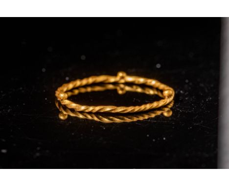 Ca. AD 800 - 1000 Viking gold ring with round, twisted hoop embellished with gold pellets every one-third of the hoop. This r