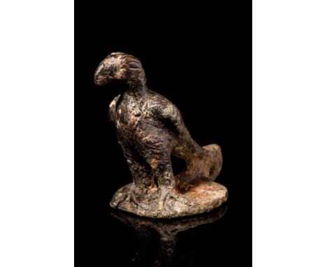 Ca. AD 100 - 300 A freestanding bronze figurine of an eagle made in a stylised manner, perching atop a rock with its sharp cl