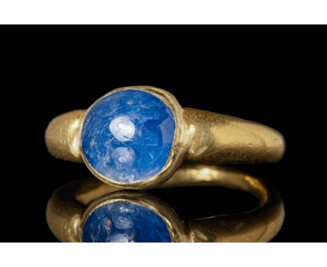 Ca. AD 400 - 600 A Roman gold ring composed of a simple and elegant gold hoop widening to the shoulders. Pinned to the bezel 