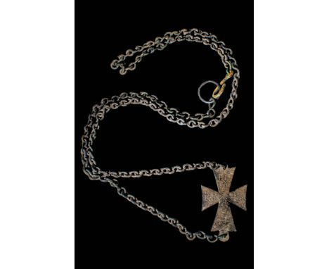 Ca. AD 800 - 1200 A Byzantine bronze cross adorned with an inscription in Greek letters made with stamped dots. On the lower 