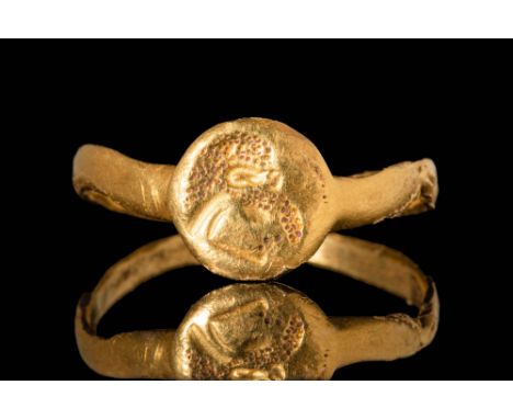Ca. 300 - 100 BC A Punic or Hellenistic gold ring with a circular bezel, depicting a profile of a man's head facing left. The