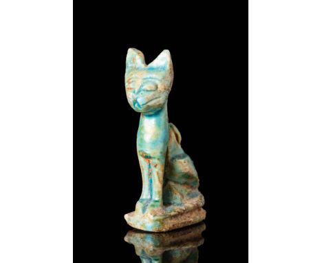 Ca. 664 - 332 BC An Egyptian green faience amulet depicting a cat, most likey the goddess Sekhmet, standing on its front paws