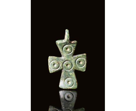 Ca. AD 400 - 600 A Byzantine bronze cross pendant decorated with five dots representing the five wounds of Christ. It has a r