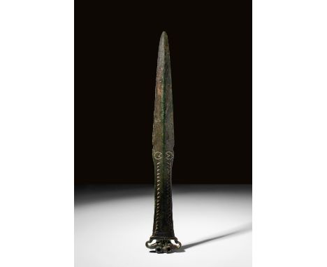 Ca. 1200 - 700 BC A European bronze dagger with decorative geometric motifs on both the handle and the ricasso. This dagger a