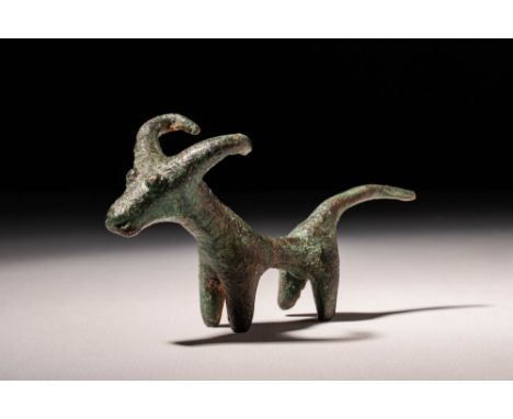 Ca. 900 - 700 BC A greek figurine of a stag represented with short curved horns. The animal stands on four little legs and ha