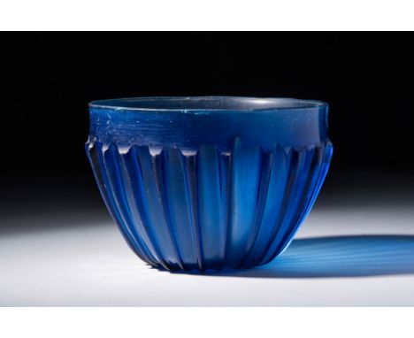 Ca. 100 BC - AD 100 A stunning Roman blue glass ribbed bowl. It is mould-made in a shallow phiale-like form, with a slightly 