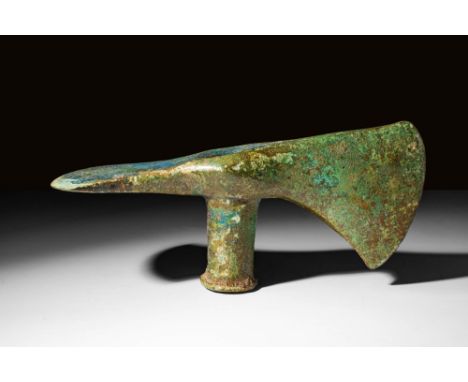Ca. 1200 - 800 BC A bronze socketed axe head with a curved blade edge, a slender, socketed neck, and a pickaxe blade on the r