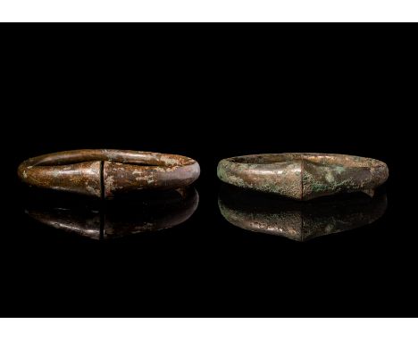 Ca. 100 BC A pair of Celtic bronze bracelets with a thick composition cast. These heavy accessories have a round hoop widenin