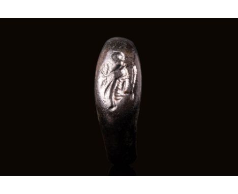 Ca. AD 100 - 300 A Roman bronze ring with an oval-shaped bezel engraved with a left-facing depiction of the goddess Victory g