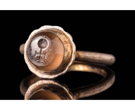 Ca. AD 500 - 700 A Byzantine gold finger ring with a circular hoop connected with a large flower-shaped bezel. Secured to the