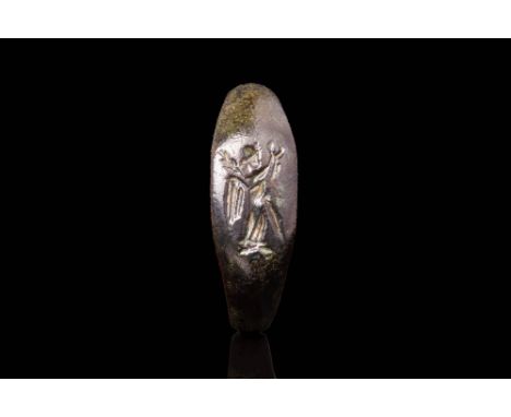 Ca. AD 100 - 300 A Roman bronze ring featuring a round hoop that transitions smoothly into a flat section. The elongated beze