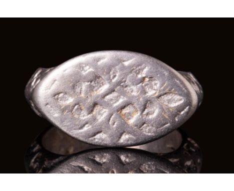 Ca. AD 900 - 1200 A Byzantine silver ring with an almond-shaped bezel engraved with a stylised plant motif. The hoop has a ce