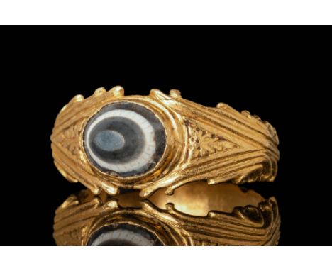 Ca. AD 100 - 300 A Roman gold ring comprising of an angular hoop adorned with stylised acanthus leaves within a triangular le