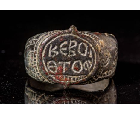Ca. AD 800 - 1300 A Byzantine bronze ring with an ogival bezel showing an inscription on two registers. The side panels are d