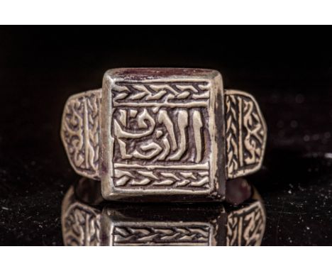 Ca. AD 1500 - 1800 An Ottoman bronze ring with a large square bezel inscribed in the main register and embellished on the top