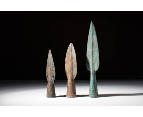 Ca. 1500 - 1200 BC A group of three bronze European spearheads. The first from the left features a hole on each wing, possibl