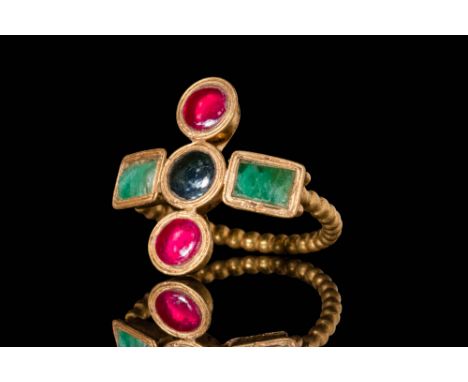 Ca. AD 400 - 600 A Late Roman gold ring with five bezels which form a Greek cross. There are two round red garnet cabochons o