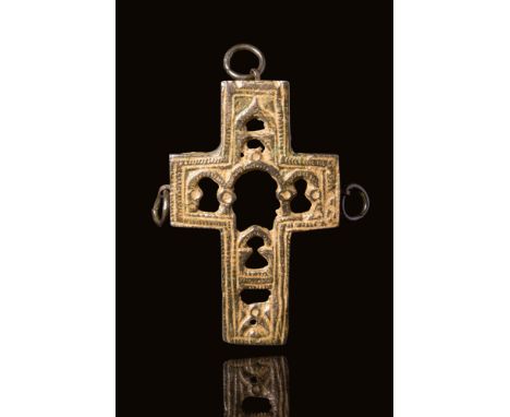 Ca. AD 800 - 1200 A well-preserved bronze reliquary pendant with open-work decoration. The decoration is in the facade of a t
