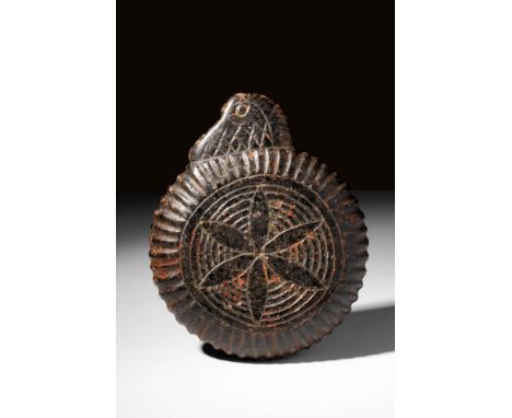Ca. 600 - 300 BC A heavy stone dish with low, straight walls. One side bears a flat, roughly triangular handle with an incise