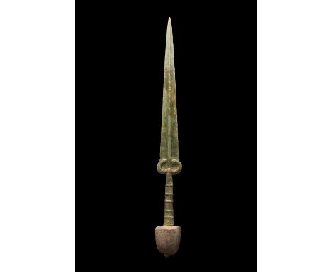 Ca. 900 - 700 BC An extremely fine bronze sword featuring a thin sharp blade with a prominent midrib and a cylindrical hilt. 