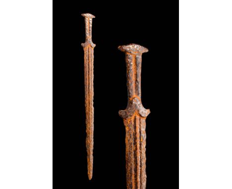 Ca. 600 - 200 BC A Scythian iron acinaces dagger featuring a short, double-edged blade adorned with two ridges that run symme
