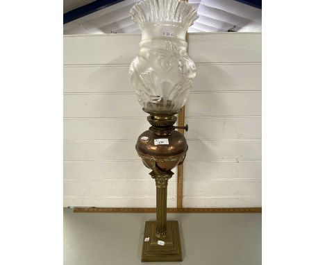Oil lamp with corinthian column brass base and a copper font fitted with frosted floral decorated shade