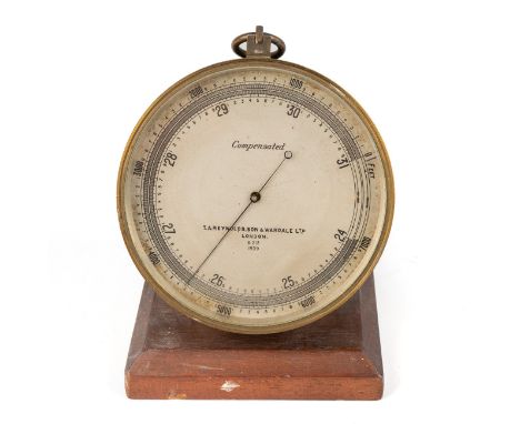 WW2 era compensated aneroid barometer by TA Renolds.son and Wardale LTD, dated to dial 1939 on a wooden stand light Scratch t