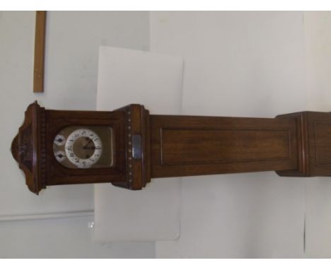 Edwardian oak longcase clock, arched hood enclosing a circular dial with Arabic numerals above an egg and dart frieze, panell