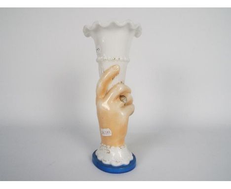 A late 19th or early 20th century glass vase in the form of a hand holding aloft a cornucopia, approximately 21 cm (h).