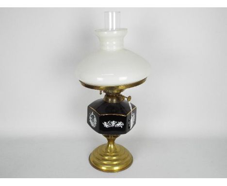 A brass oil lamp with ceramic reservoir and milk glass shade, approximately 54 cm (h) including chimney.