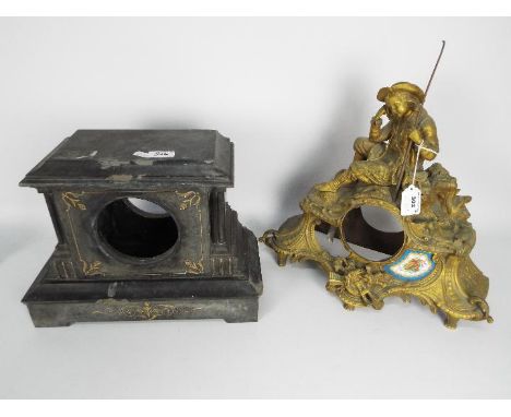 Two mantel clock cases, one a figural brass example, the other black slate with gilt highlights, largest approximately 40 cm 