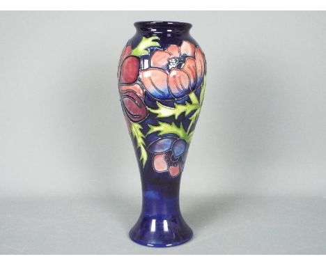 Moorcroft - A Moorcroft Pottery vase of inverted baluster form decorated with anemone against a blue ground, impressed marks 