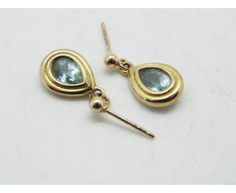 A pair of 9ct gold stone set earrings, set with light blue stone, approximately 2 grams all in.