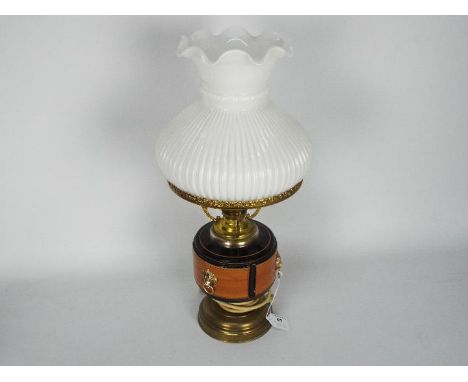 A converted oil lamp, brass with ceramic reservoir and milk glass shade, approximately 48 cm (h).