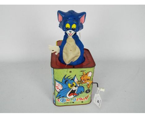 A vintage tin plate Tom and Jerry Jack In The Box by Rosebud Mattel.