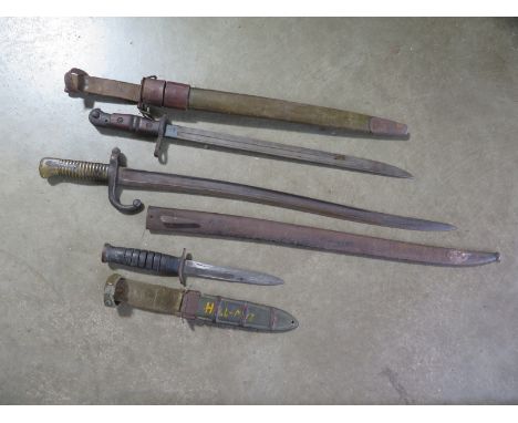 Two Bayonets and a fighting knife, to include an American 1917 Bayonet with scabbard, blade length 57cm, and a knife - some p