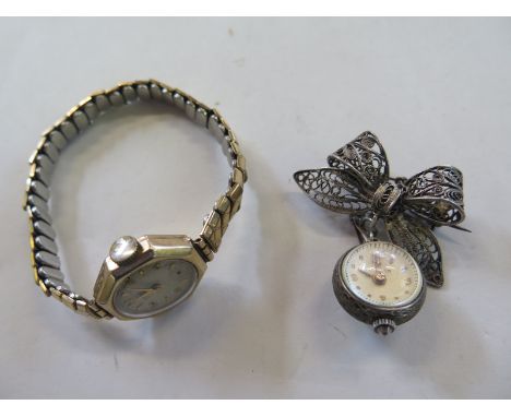 A Bucherer ladies manual wind ball watch, ladies lapel badge 18mm diameter, not working and a ladies manual wind watch, runni